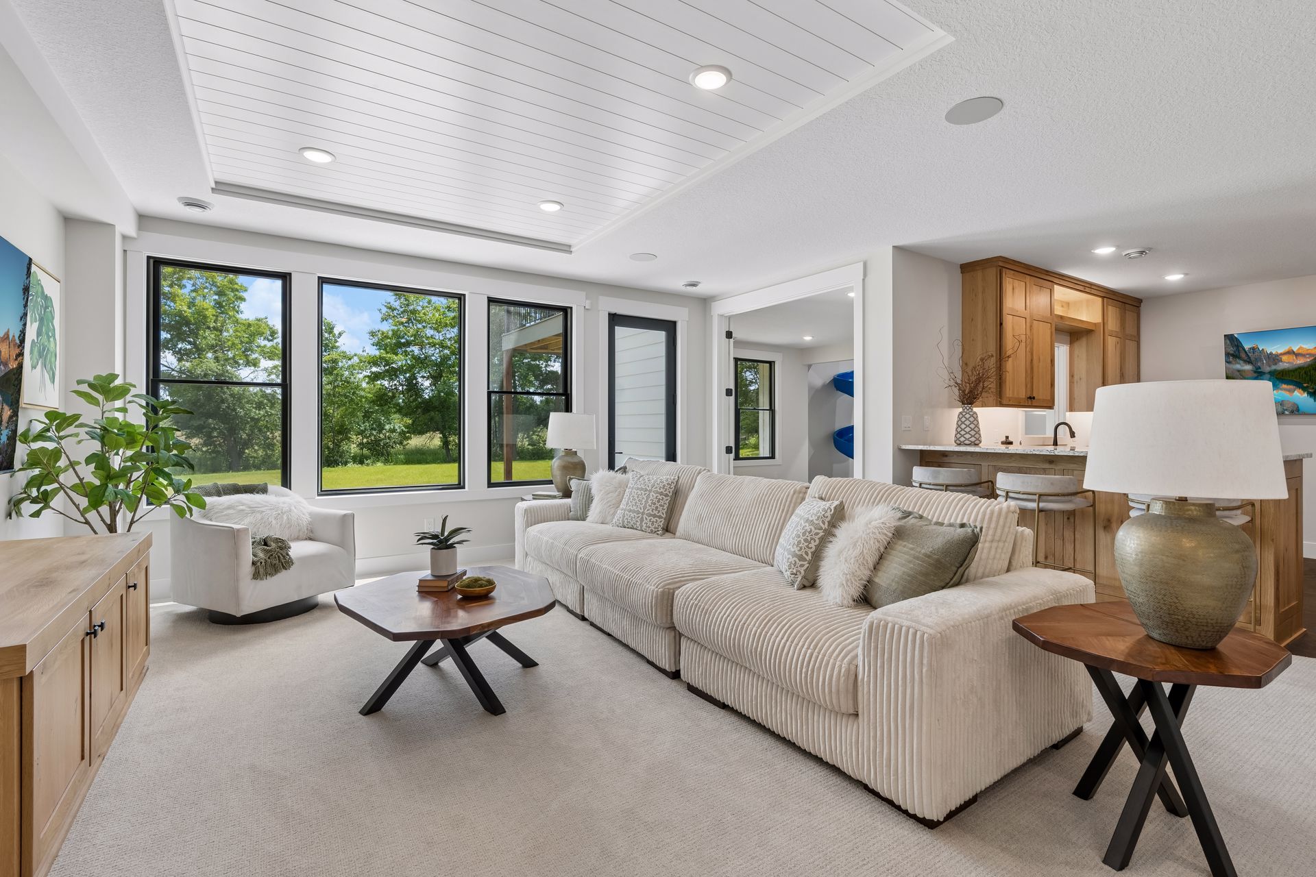 Lower level family room with comfortable seating, wet bar and backyard views